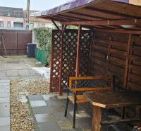 Entrance to the courtyard of a family house in Bratislava - Podunajské Biskupice with a shelter and a bench.
