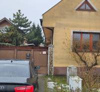 A family house in Bratislava - Podunajské Biskupice, a car parked in front of the gate.