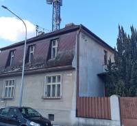 A family house on Štúrova Street in Piešťany with a car and a tall tree in the background.