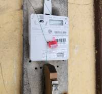 There is an electric meter with a seal placed on the wall in the family house.