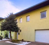 A family house on Hrabová Street in Hamuliakovo with a green facade and a garage.