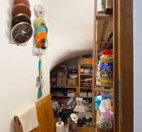 Pantry in a family house with shelves full of supplies and kitchen utensils.