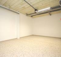 Family house with a concrete floor and ceiling pipes, white walls.