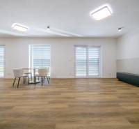 Living room in a family house with a wooden decor floor and a dining table.