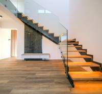 A staircase with glazing and a wooden decor floor in a family house.