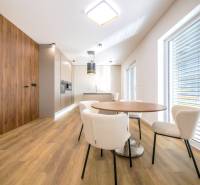A kitchen with a wooden decor floor and a dining table in a family house.