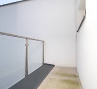 A balcony in a family house on Legionárska Street in Trenčín with glass railings.