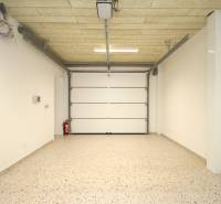A spacious garage with white walls and floor in a family house.