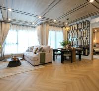 Living room in a 3-room apartment with a sofa, wall decor, and a wooden-patterned floor.