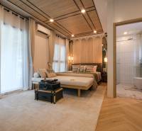 Bedroom in a 3-room apartment with carpet and wood-patterned flooring.