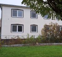 A family house in Kalná nad Hronom with a garden, a tree, and windows on the upper floor.