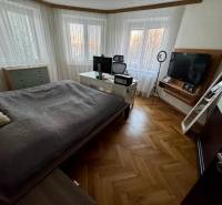 A bedroom in a 3-room apartment with a television and a floor with a wooden decor.