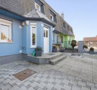 A family house on Južná Street in Miloslavov with a blue facade and a paved yard.