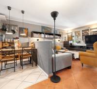 A living room in a family house with a combination of a grey sofa and a yellow armchair.