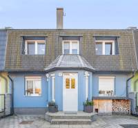 A family house on Južná Street in Miloslavov with a blue facade and a wood storage.