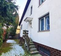 A family house on Fibichova Street in Bratislava - Ružinov with a landscaped garden and snow.