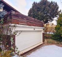 A garage at a family house on Fibichova Street in Bratislava - Ružinov surrounded by greenery in winter.