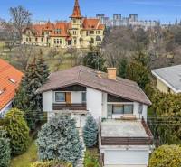 A family house on Fibichova Street in Bratislava - Ružinov surrounded by greenery and with a view of the buildings.