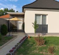 A family house in Horné Saliby with a terrace, fence, and well-maintained garden.