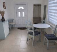 A hallway in a family house with stylish seating and furniture in pastel colors.