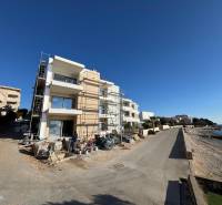 Seaside construction of 2-room apartments in Mandre by the sea, with scaffolding during construction.