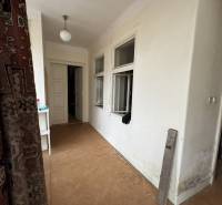 Interior of a family house with a wooden decor floor and white walls.