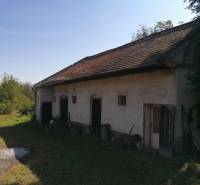 A family house on SNP Street in Šahy with a grassy plot and a sloped roof.