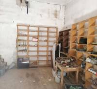 Tool shelf in the interior of a family house, items stored on wooden shelves.