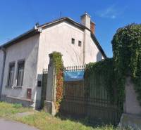 A family house on SNP Street in Šahy with a gate covered in greenery.