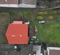A family house in Podhradie in Svätý Jur with a red roof and a green garden.