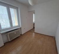 A room in a 2-room apartment with a wooden decor floor and a paper lamp.