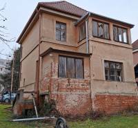 A family house on Levická Street in Vráble with plaster and a brick foundation.