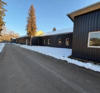 The area of warehouses and halls on Pšurnovická Street in Bytča with a snow-covered road.