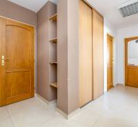 The interior of a family house with tiles, wooden doors, and built-in wardrobes.