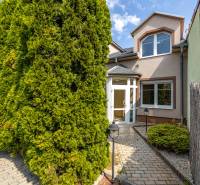 Family house on Bencúrova Street in Bratislava - Ružinov with greenery and a sidewalk.