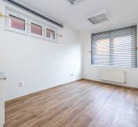 A room with windows and blinds, a sink, and a wooden decor floor in a family house.