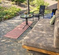 A cottage near Zvolen with a terrace, comfortable seating, a wooden-patterned floor, and a garden table.
