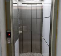 Elevator with a lighted ceiling in the entrance hall.