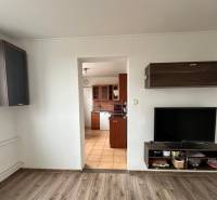 Living room with entrance to the kitchen and a wooden decor floor in a 4-room apartment.