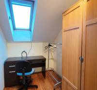 Corner office in a family house with a wooden decor floor and a skylight.