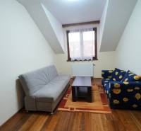 Living room in a family house with sofas, a coffee table, and a wooden decor floor.