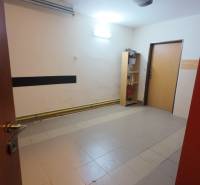 Interior of a family house with tiles and a shelf, neutral walls.