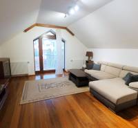A bright living room with a comfortable sofa and a wooden decor floor.