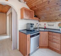 A kitchen in a family house with wooden decor and a coffee maker on the kitchen counter.
