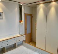 Bedroom in a 3-room apartment with white wardrobes and built-in lighting.