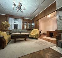 Living room in a 3-room apartment with a sofa, chandelier, and decorations.