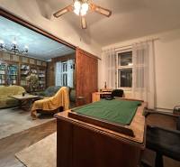Interior of a 3-room apartment: desk, bookshelf, sofa set, floor with wood decor.