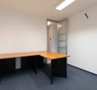 A work corner with a corner desk and a blue carpet in a 4-room apartment.