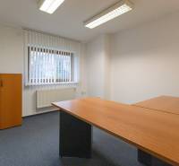 Office in a 4-room apartment with a wooden table and wardrobe, bright interior.