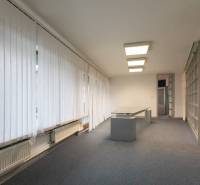 Interior with an office desk, light flooring, and vertical blinds in a 4-room apartment.